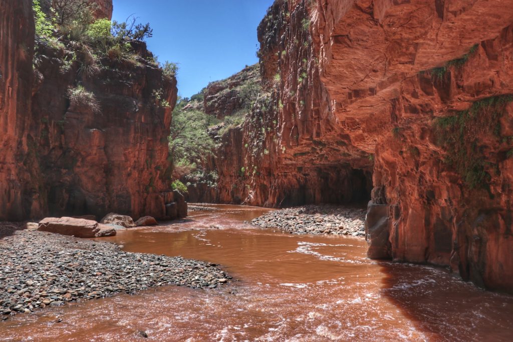 Canyon with water flowing from the Cibecue Falls with erosion in the canyon side.